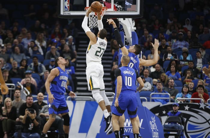 Rudy Gobert (27) dunks over Nikola Vucevic (9) and Aaron Gordon (00)